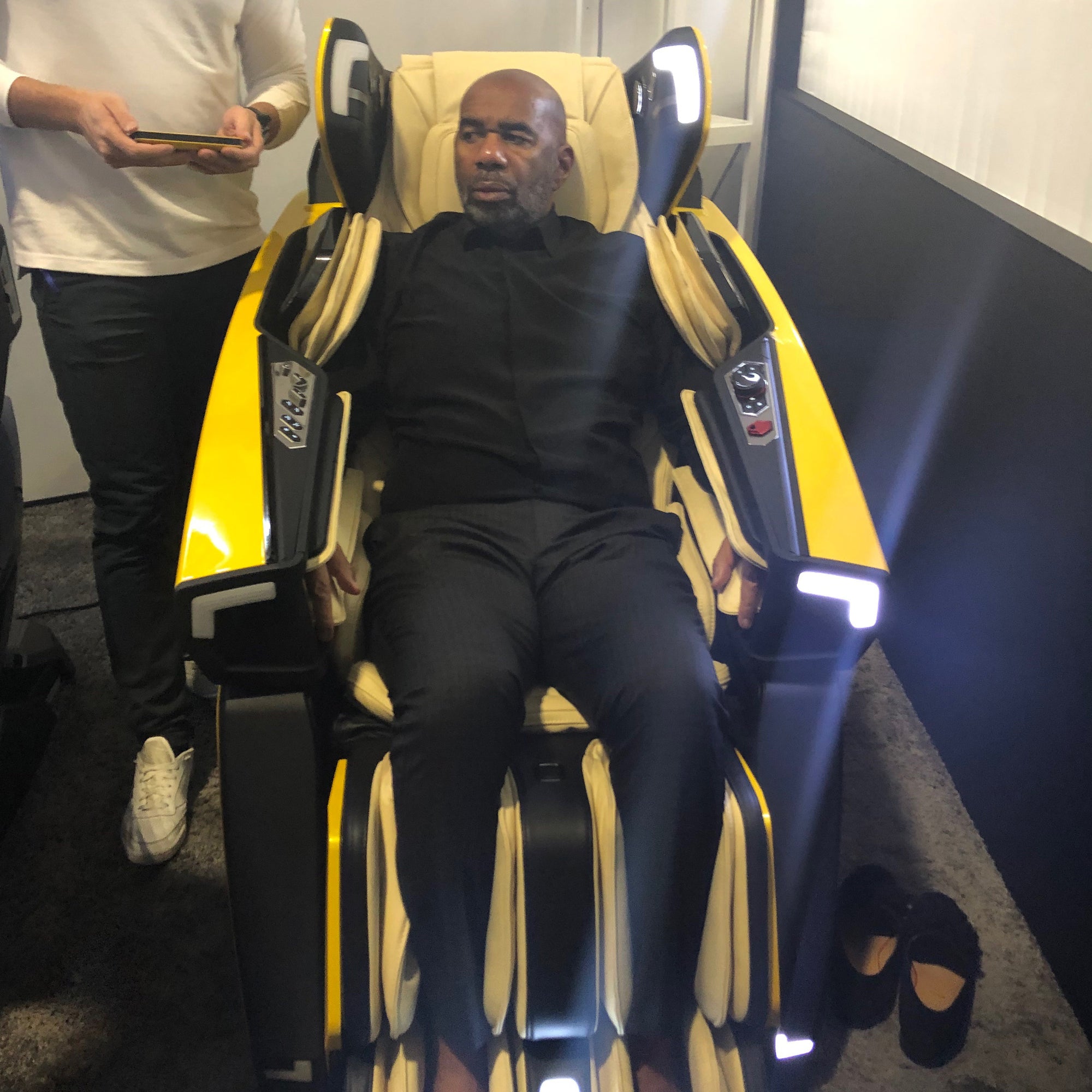 A gentleman is trying the Lamborghini massage chair.
